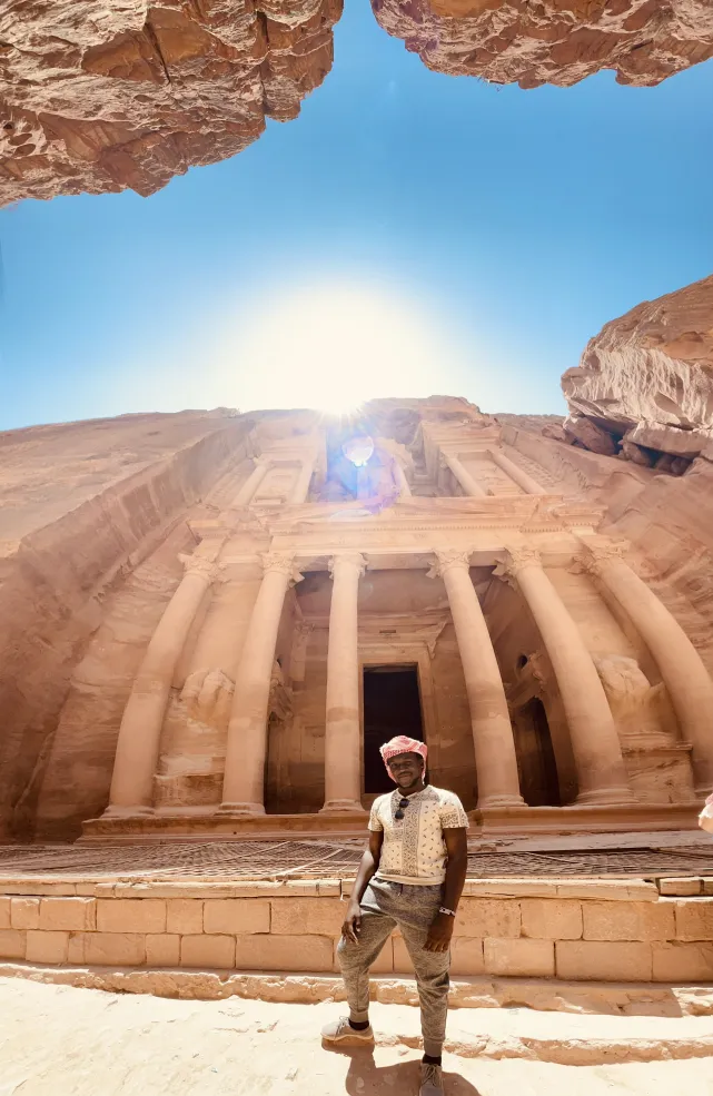A photo of the writer in front of Al-Khazneh temple