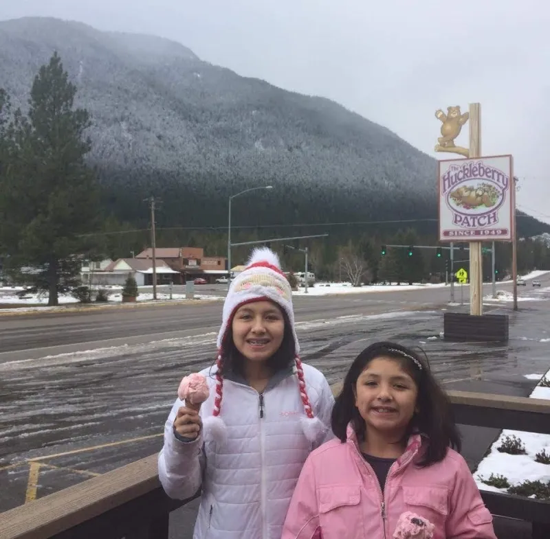 Writer and sister holding ice cream in front of a mountain