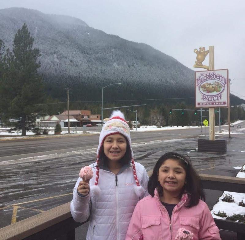 Writer and sister holding ice cream in front of a mountain