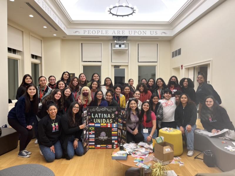 LU students gathered around a poster for a photo