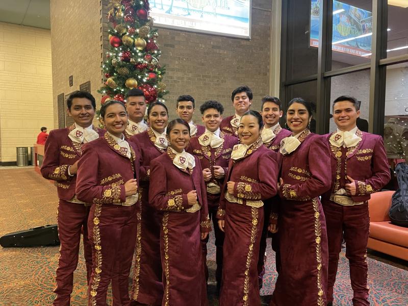 A group of Harvard students standing in their mariachi suits