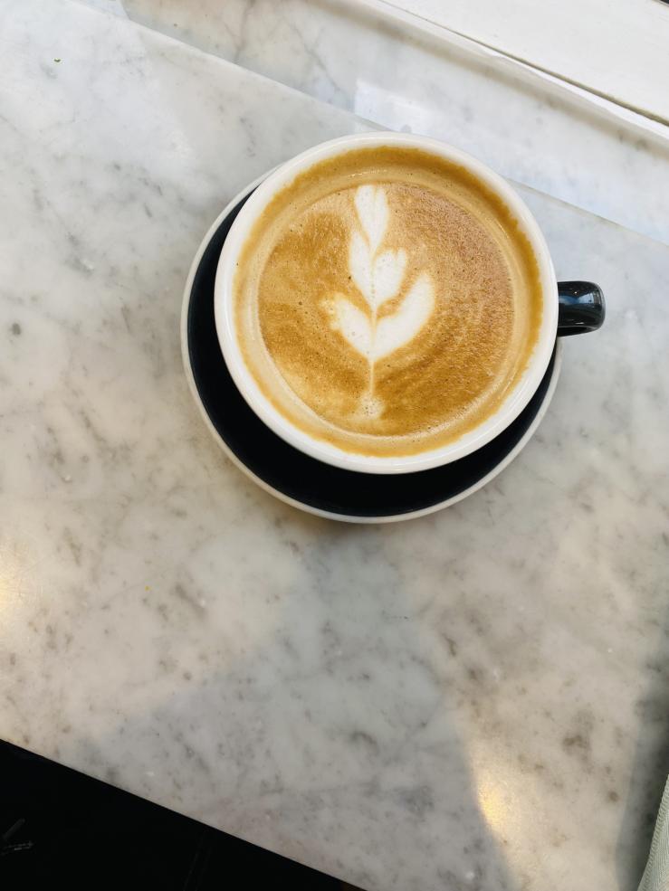 A cappuccino cup on a marble counter