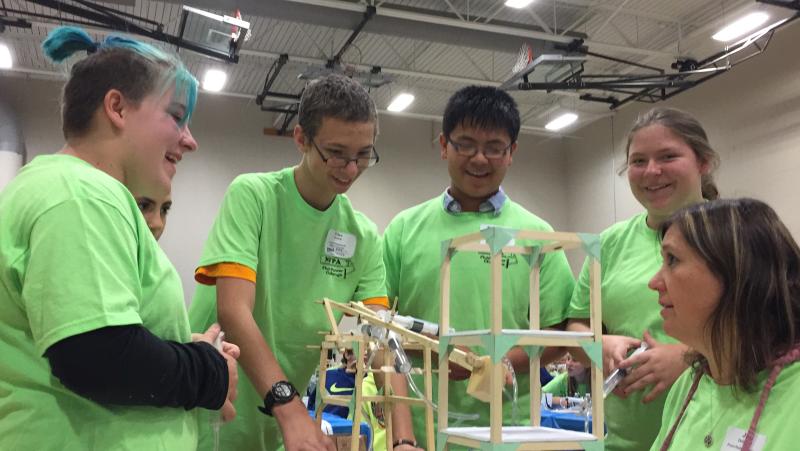 Picture of author and his friends in green shirts building a contraption