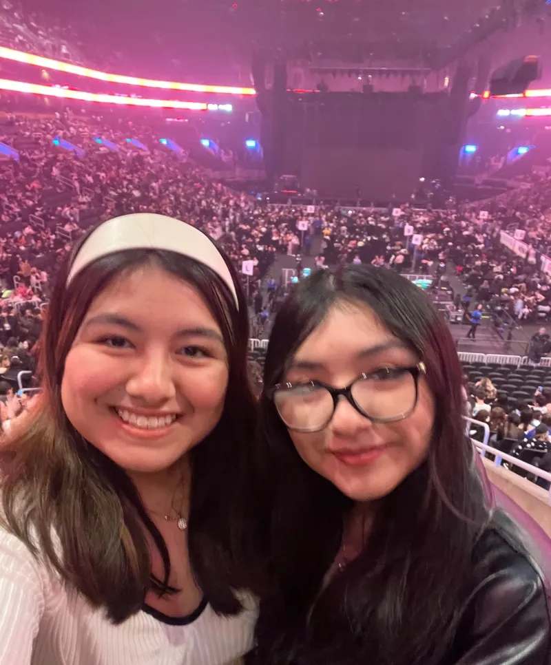 Two people taking a selfie at a concert venue