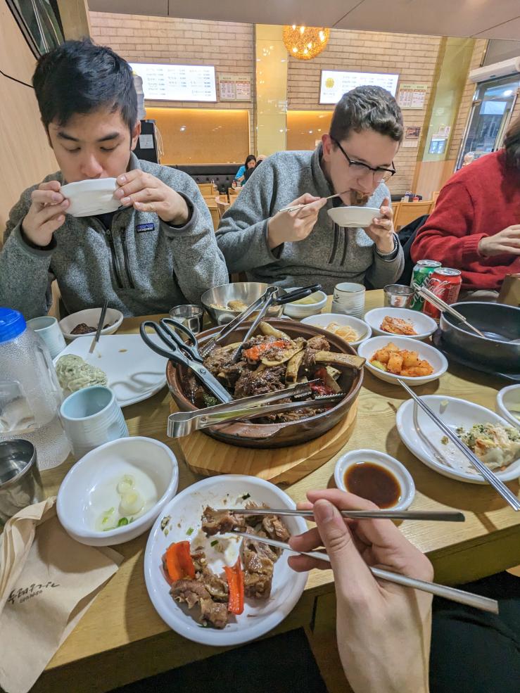 A picture of me and two of my friends eating some amazing Korean food