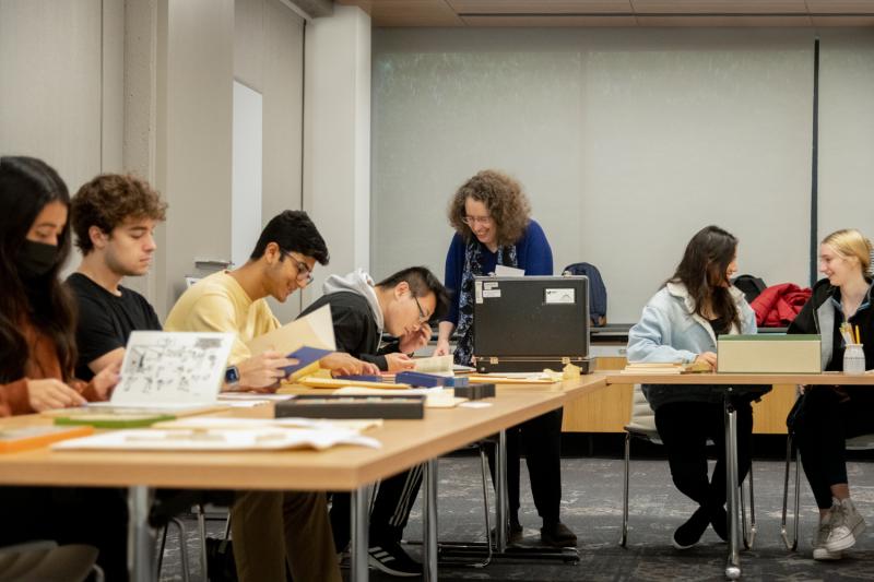 Students doing work while professor walks around