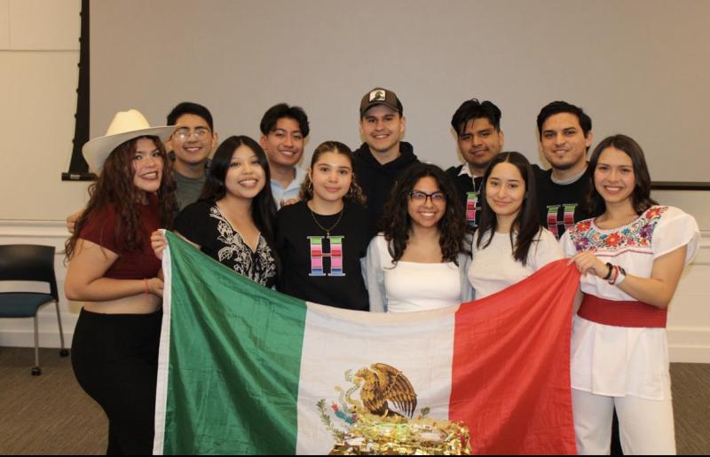 An image of the 11 board members for RAZA of the 2023 year. They are holding up a Mexican flag.