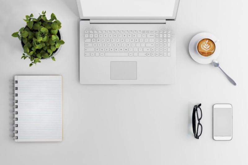 Desk with laptop, planner, and other tools.