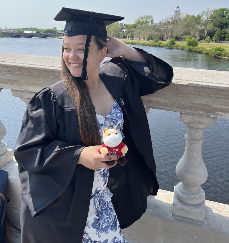 Harvard Grad Perrin P in her regalia on John Weeks Bridge