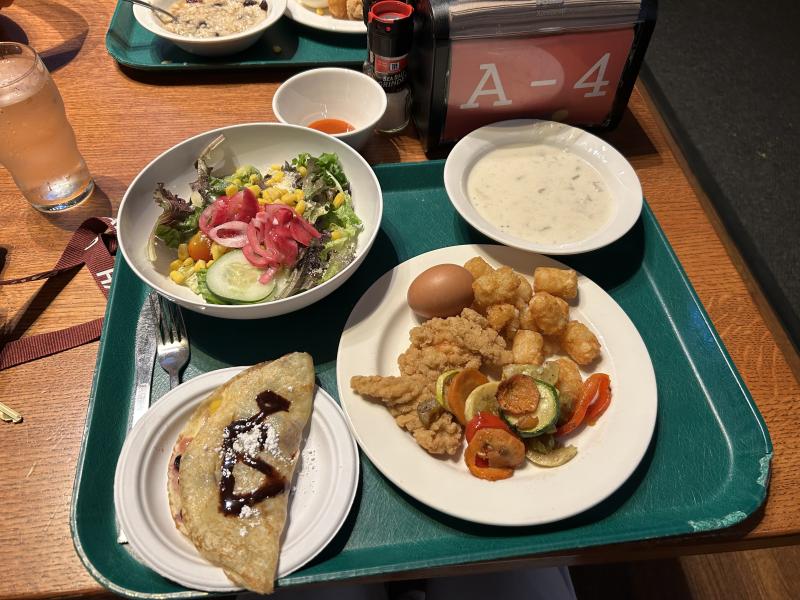 Picture of dining hall food with salad, crepes, and breakfast spread