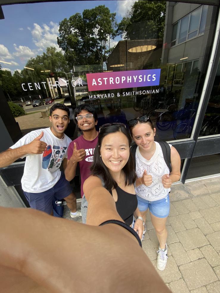 A selfie of Rafid with friends standing outside of the Center for Astrophysics