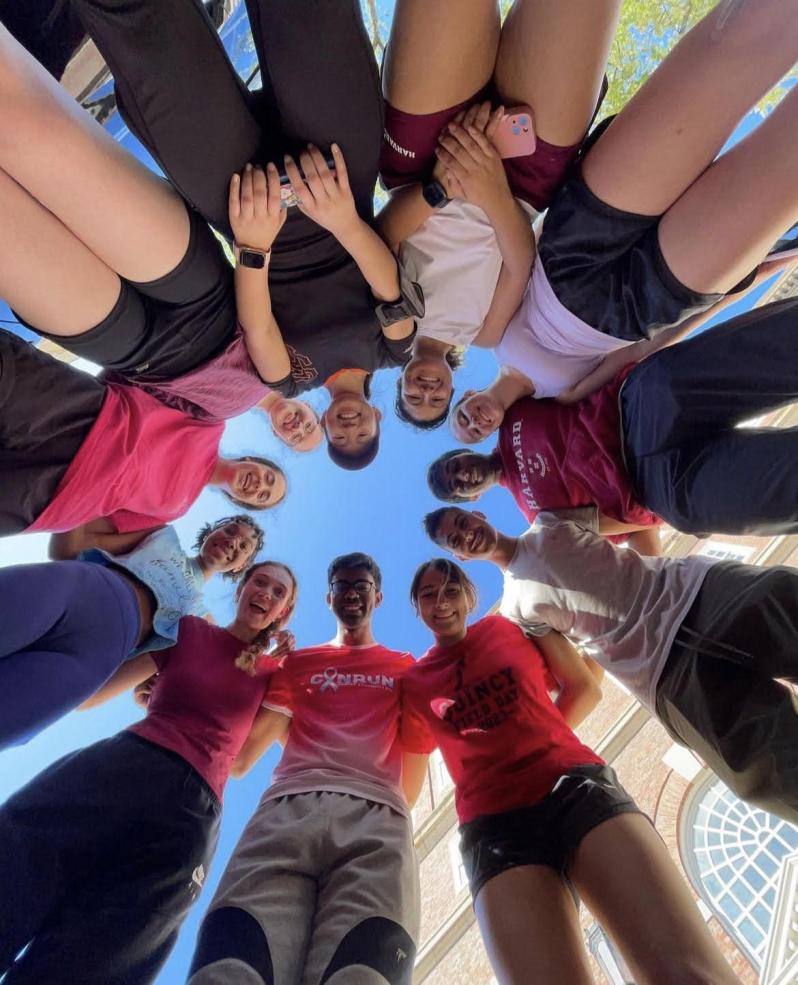 A group of runners looking down at a camera.