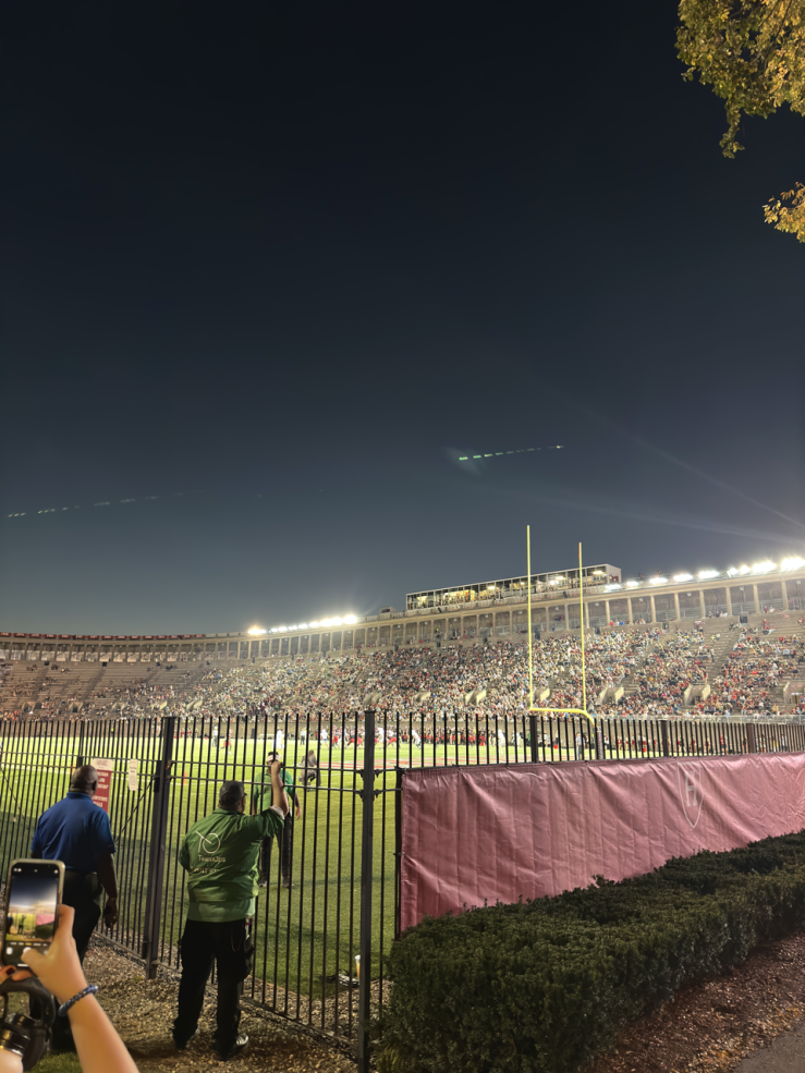 Image of the corner of a fence enclosing a football field 