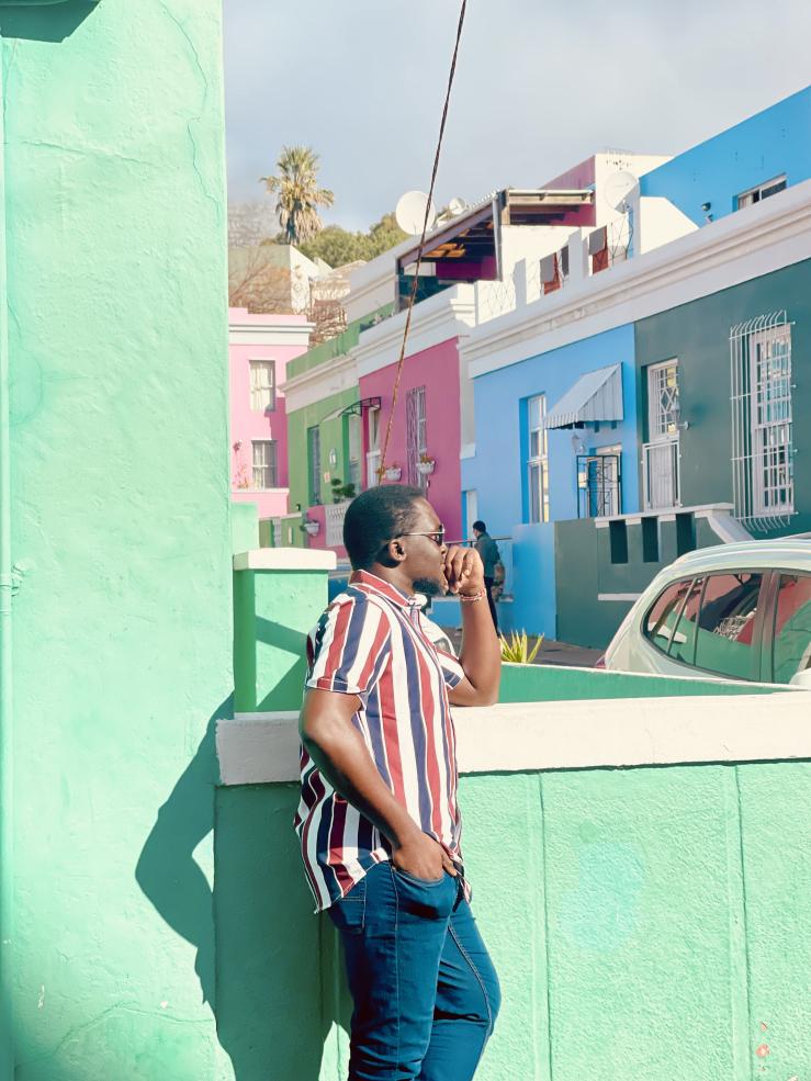 Posing for a photograph by colorful houses