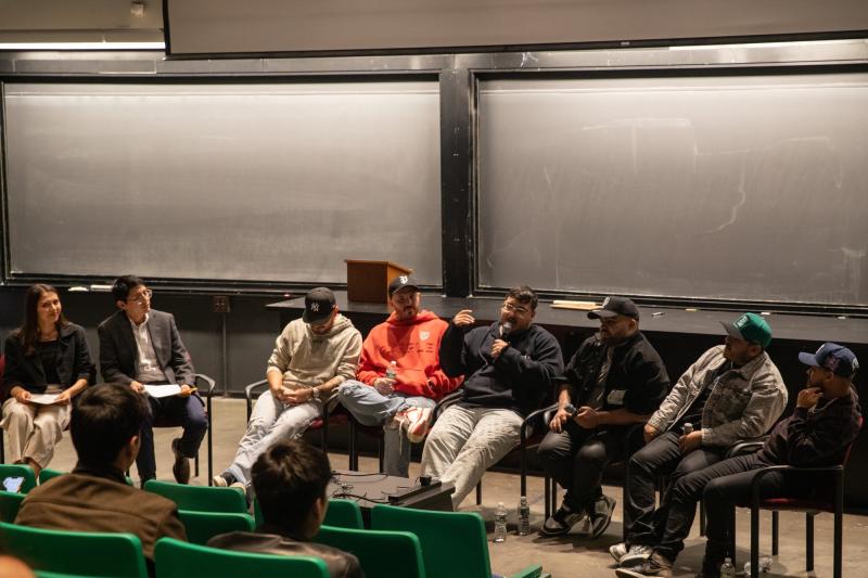 Picture of Grupo Frontera band members sitting in front of a Science Center lecture hall, being interviewed by two individuals ( Ana Barba and Bryant Valenzuela).