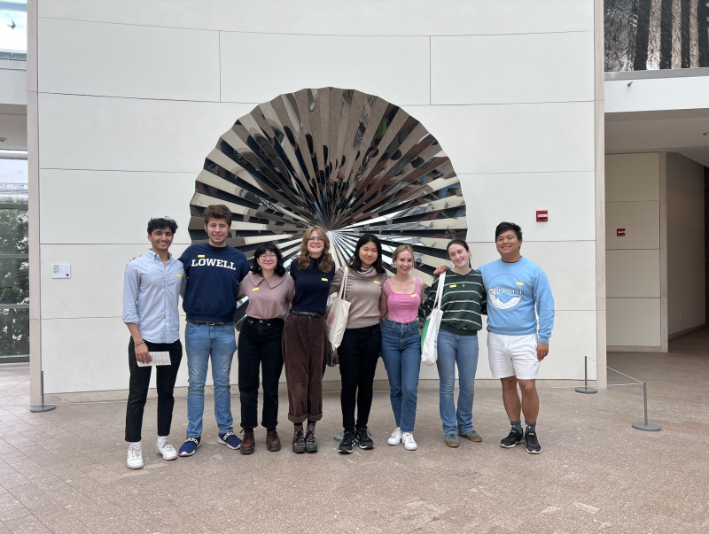 Eight students posing for a group photo