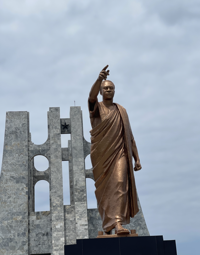 A photograph of a bronze-colored statue of Kwame Nkrumah