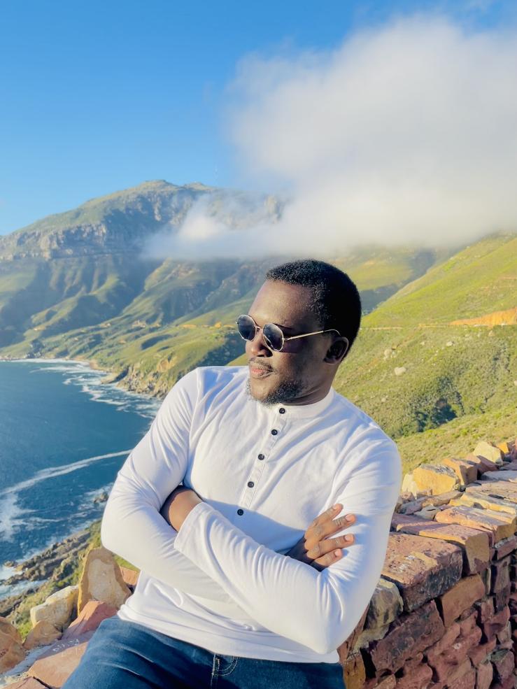 Posing with a view of mountains and the ocean