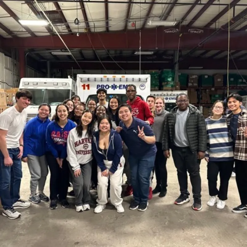 Students posing in front of an ambulance for a group picture