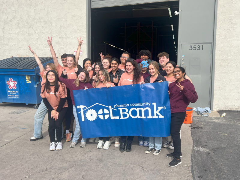 Group photo standing with Phoenix Tooldbank sign