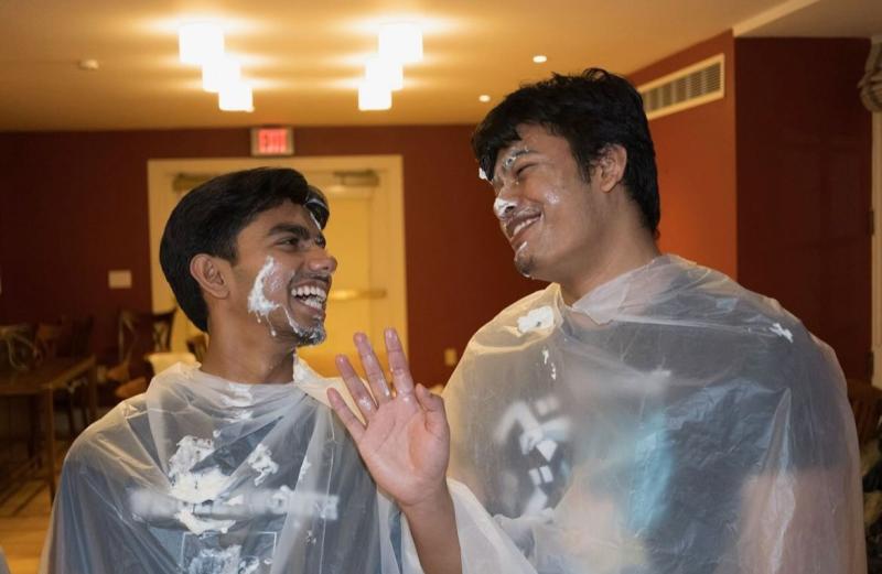 Two students participating in Pie-in-the-Face Fundraiser