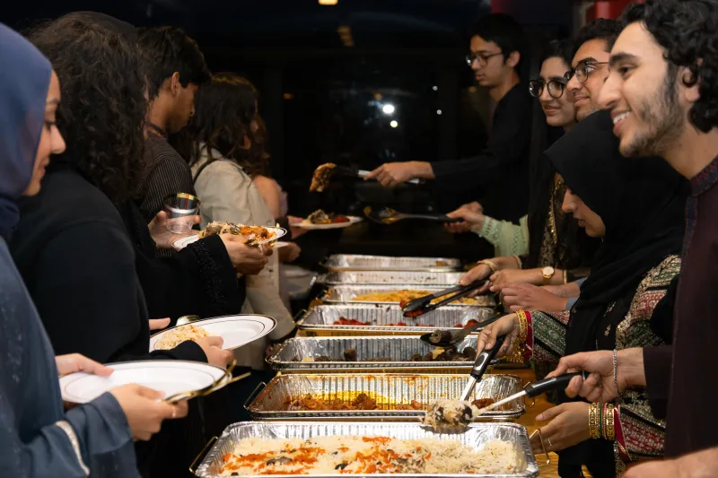 Students serve other students food for Chaand Raat.