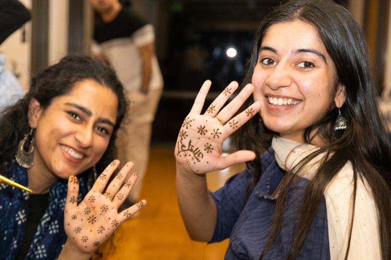 Students get henna designs on their hands.