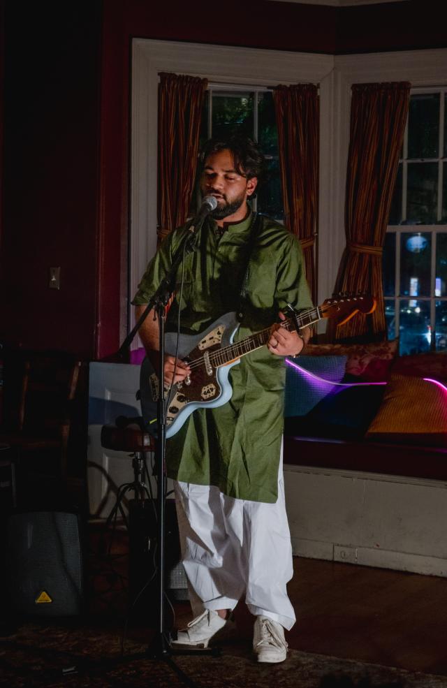 One of the co-presidents of the Signet performs a song in Urdu, Asmer