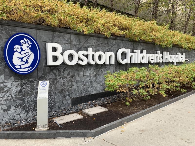 Picture of a Boston Children's Hospital sign placed across a stone wall.
