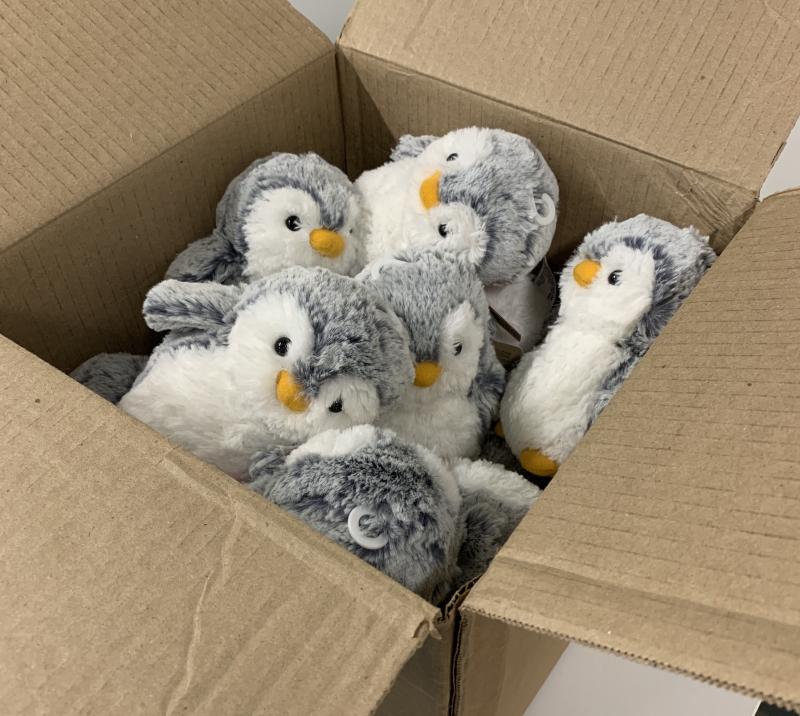 Picture of penguin plushies in a box.