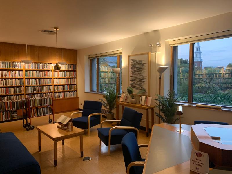 Picture of the Lamont Poetry Room, looks to be a room filled with books in a very aesthetic manner.  