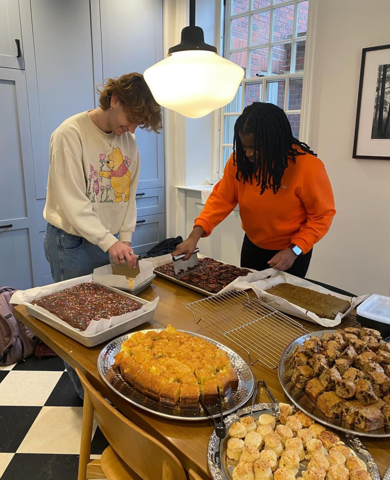 My coworker and I cutting treats to be served at Lowell Tea.