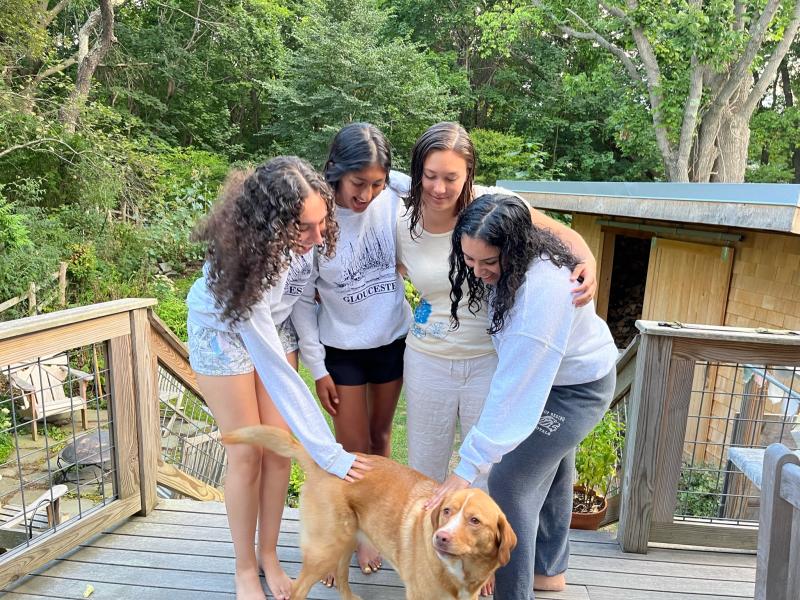 Hana Rehman and her friends petting her friend's dog. 