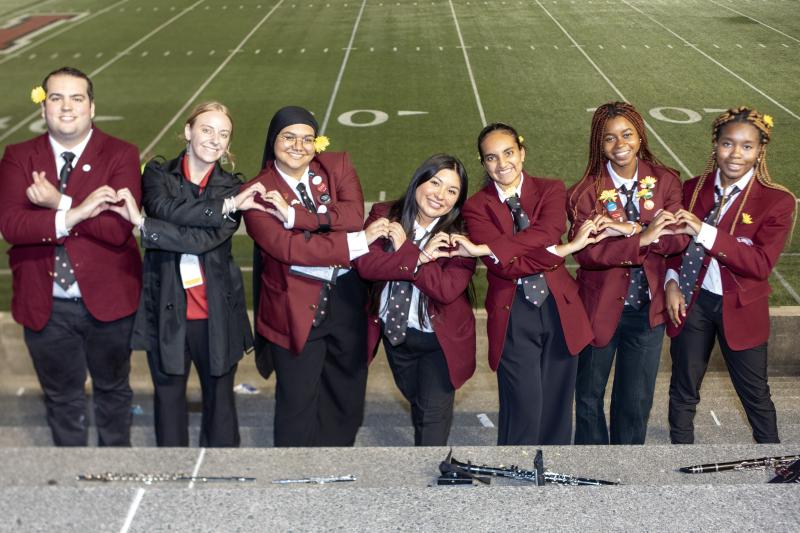 Group of students making heart signs
