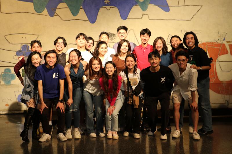 Students in TCS huddled together in a group photo after the nightmarket event