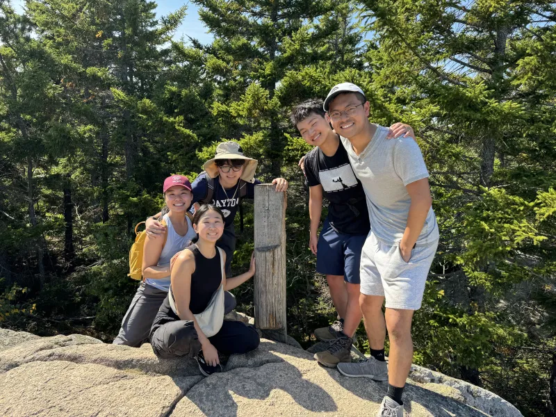 Group picture of the author and his blocking group standing next to a wooden signpost that read "Beehive Summit."