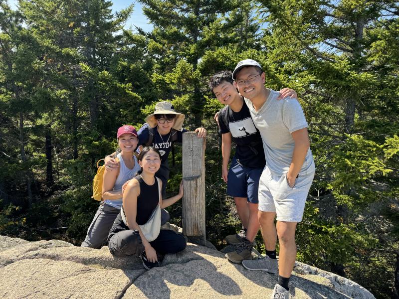 Group picture of the author and his blocking group standing next to a wooden signpost that read "Beehive Summit."