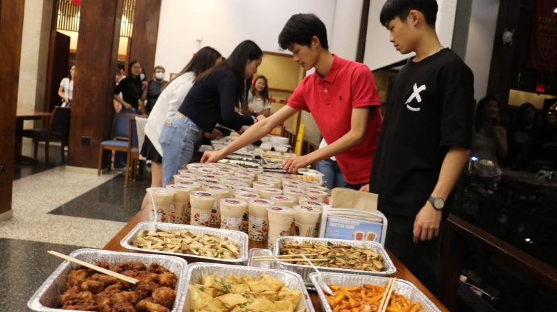 Students serving various Taiwanese foods at the night market event