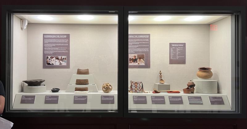 Exhibit showing artifacts such as clay pots and woven bags