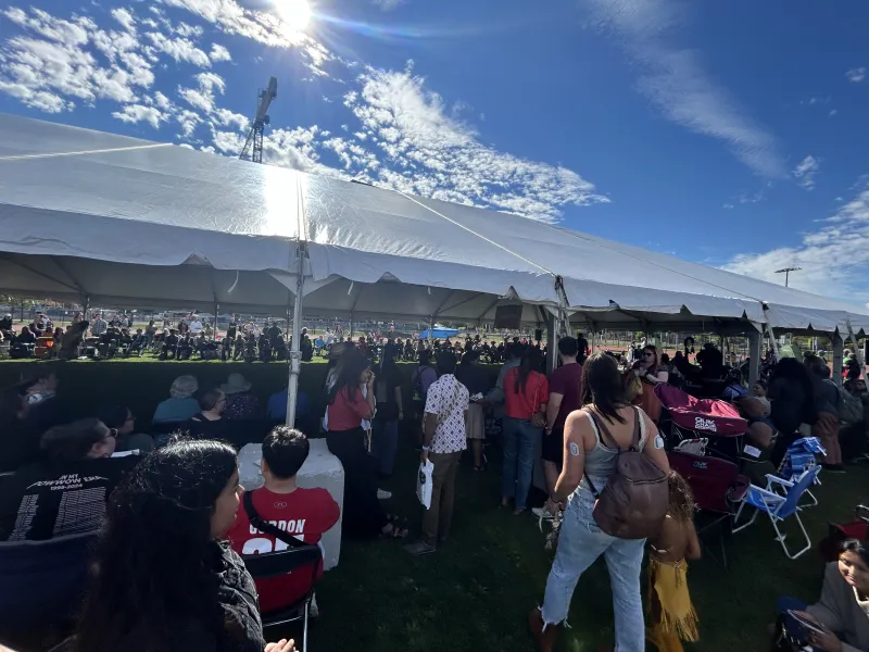 People gathered around the dancing arena at the Harvard Powwow