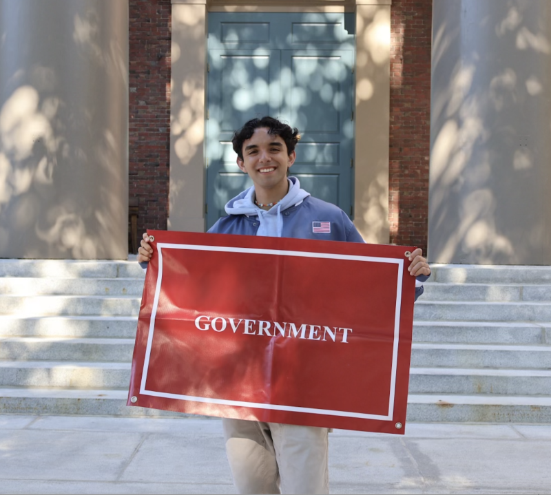 2nd Year Student Posing with a Poster Labeled Government 