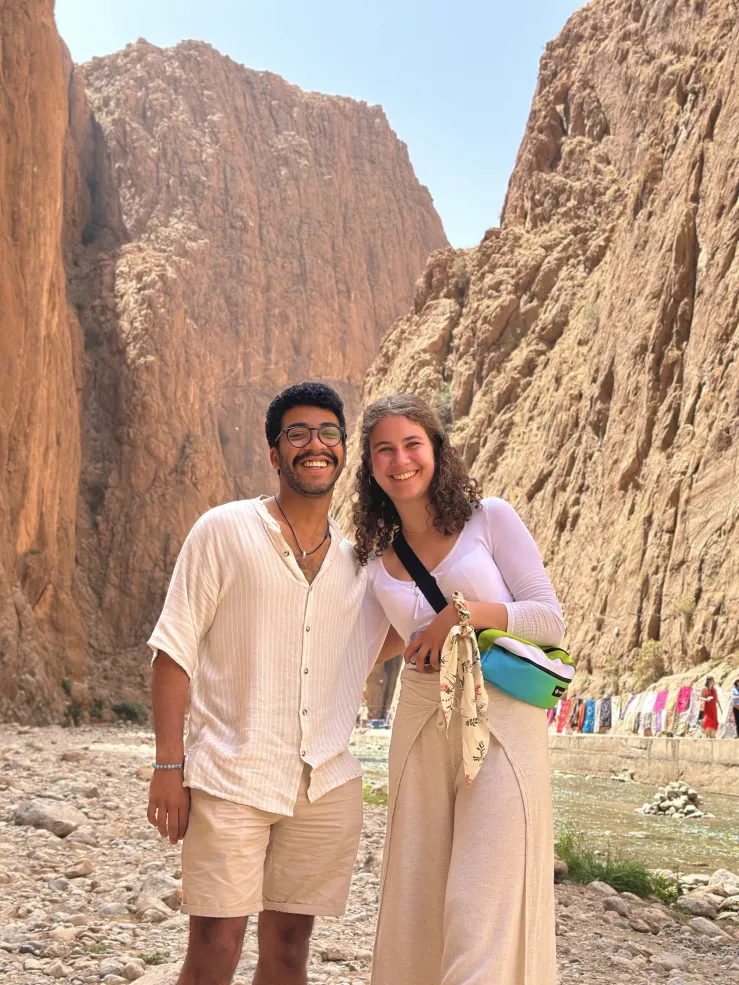 Jose and Ida, a Harvard friend, standing in front of rocky mountains in Morocco.