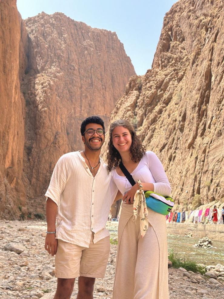 Jose and Ida, a Harvard friend, standing in front of rocky mountains in Morocco.