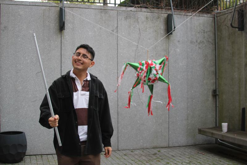 RAZA's Vice-President holding a stick to hit a piñata at RAZA's spring farewell Mesa (social event). 