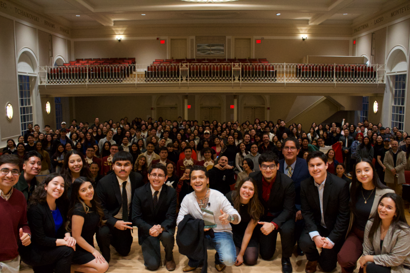 A picture of RAZA Board with Christian Nodal on Paine Hall stage. behind them is the audience that attended the 2024 Trailblazer Award Ceremony. 