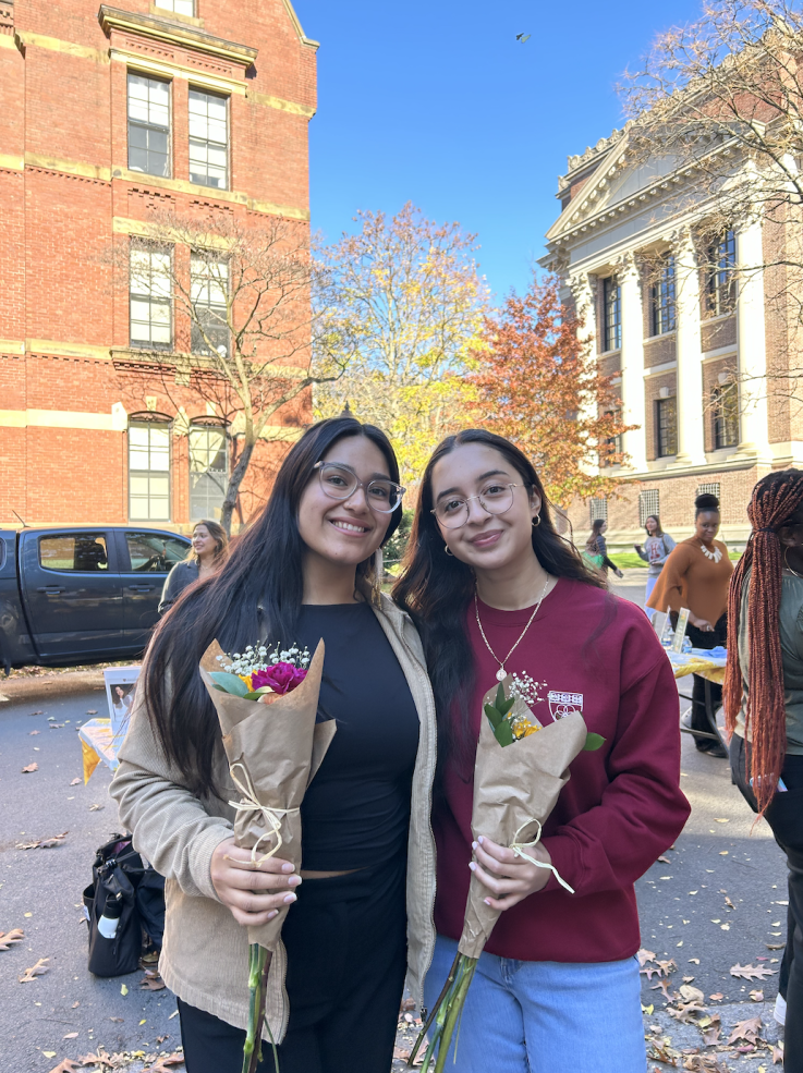 Lizbeth with her friend Amber holding flower bouquets.