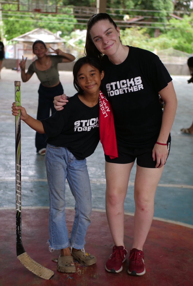 Gaby Davidson Adams and girl from Stick Together Program posing together for a picture