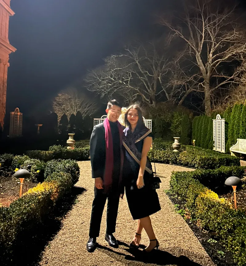 Ana and Hiro in formal clothes posing for a picture in the nice venue of a student org formal.