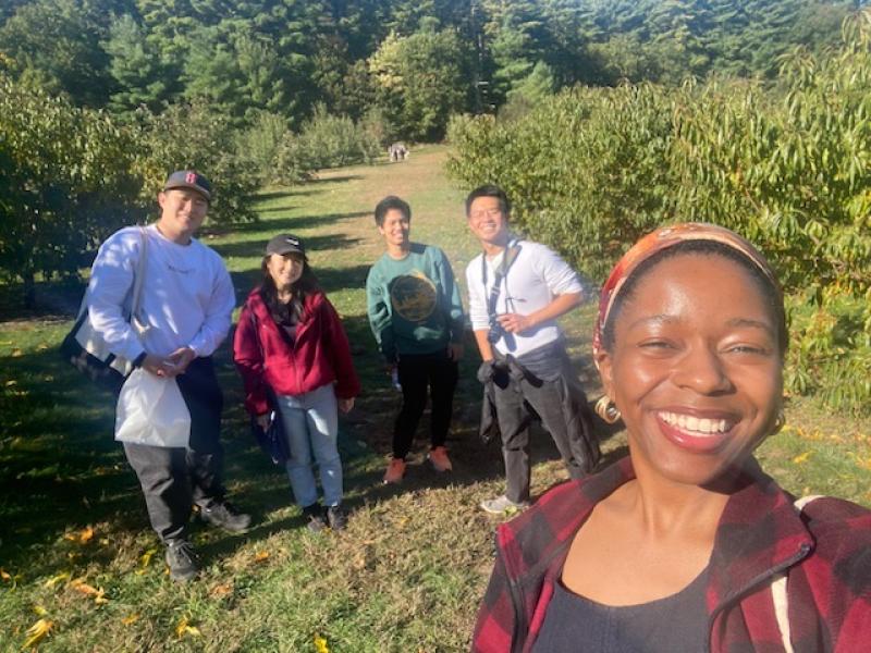 Picture of Raymond and his friends in an apple orchard.