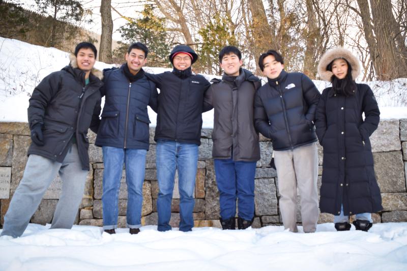 Picture of Raymond and his friends standing in front of the Salem Witch Trials Memorial in Salem, MA.